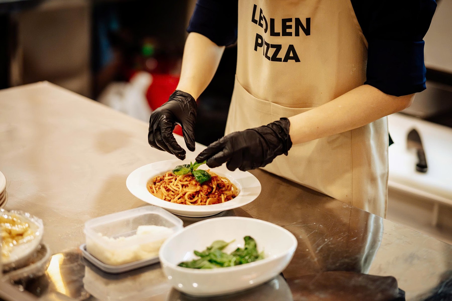 Pasta being finished in LeoLen Pizza's kitchen