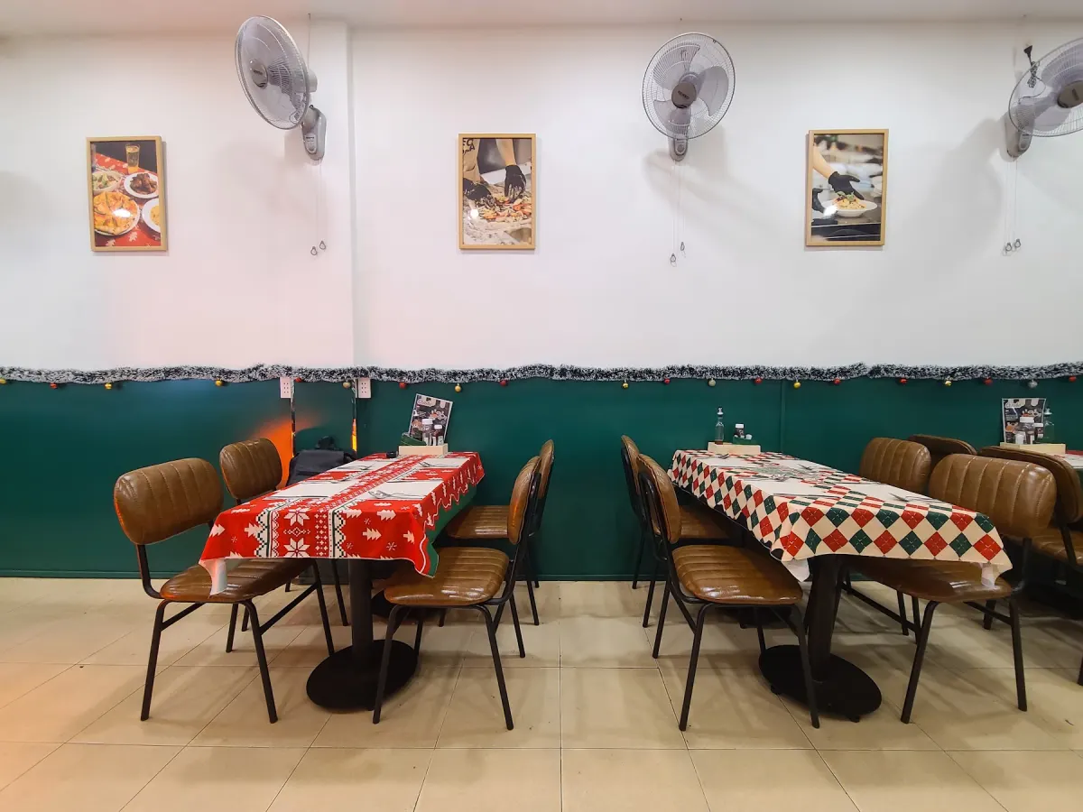 The cosy dining room with red-check tables at LeoLen Pizza, Binh Thanh